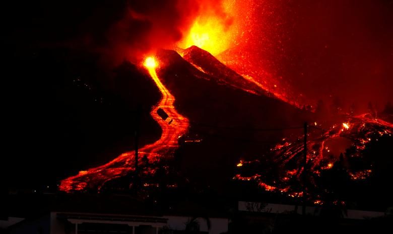 Lava flows next to a house following the eruption of a volcano in the Cumbre Vieja national park at El Paso, on the Canary Island of La Palma, September 19, 2021. REUTERS/Borja Suarez